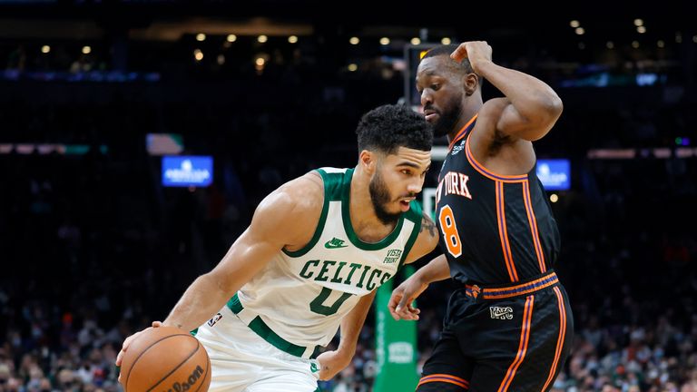 Boston Celtics forward Jayson Tatum (0) drives against New York Knicks guard Kemba Walker (8) during the first half of an NBA basketball game, Saturday, Dec. 18, 2021, in Boston. (AP Photo/Mary Schwalm)


