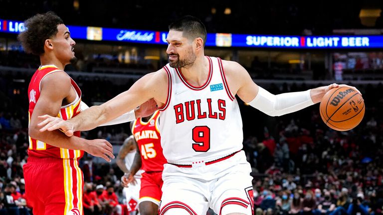 Chicago Bulls center Nikola Vucevic, right, drives against Atlanta Hawks guard Trae Young during the second half of an NBA basketball game in Chicago on Wednesday December 29, 2021. The Bulls won 131-117.  (AP Photo / Nam Y. Huh)