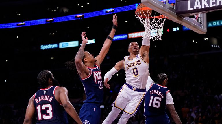 Los Angeles Lakers guard Russell Westbrook dunks the ball against Brooklyn Nets forward Nic Claxton and forward James Johnson