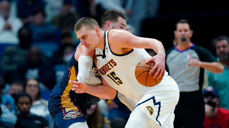 Denver Nuggets center Nikola Jokic (15) drives to the basket against New Orleans Pelicans center Jonas Valanciunas during overtime of an NBA basketball game in New Orleans, Wednesday, Dec. 8, 2021. The Nuggets won 120-114. (AP Photo/Gerald Herbert)