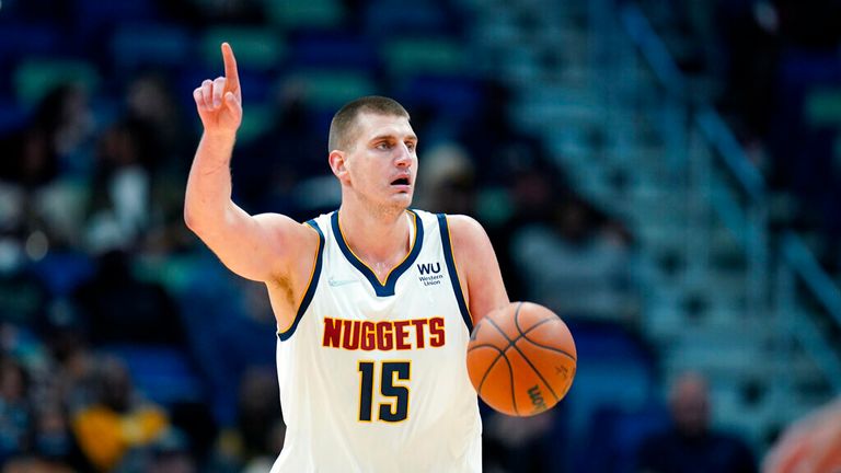 Denver Nuggets center Nikola Jokic (15) moves the ball down court in the first half of an NBA basketball game against the New Orleans Pelicans in New Orleans, Wednesday, Dec. 8, 2021. (AP Photo/Gerald Herbert)