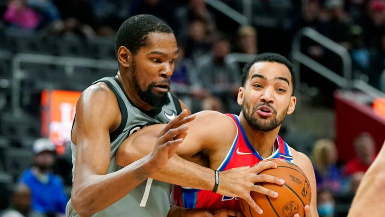 Detroit Pistons forward Trey Lyles (8) is defended by Brooklyn Nets forward Kevin Durant (7) during the first half of an NBA basketball game, Sunday, Dec. 12, 2021, in Detroit. (AP Photo/Carlos Osorio)