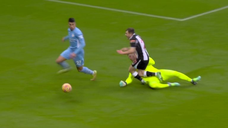 Manchester City's Ederson takes out Newcastle's Ryan Fraser but no penalty is given. 