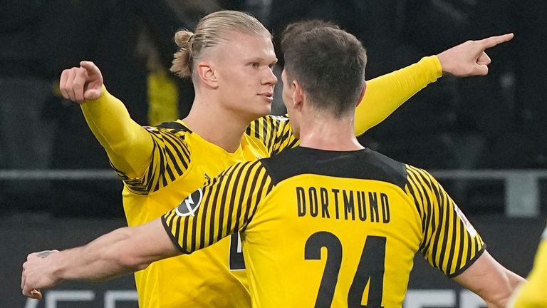 Dortmund's Erling Haaland, left, celebrates with Dortmund's Thomas Meunier after the opening goal during the German Bundesliga soccer match between Borussia Dortmund and Greuther Fuerth