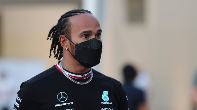 Mercedes driver Lewis Hamilton of Britain arrives for his press conference with Red Bull driver Max Verstappen of the Netherlands at the Yas Marina racetrack in Abu Dhabi, United Arab Emirates, Thursday, Dec. 9, 2021.