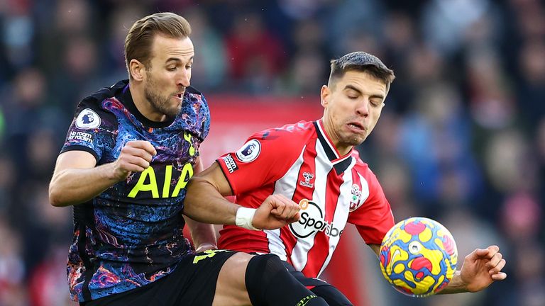 Harry Kane battles for possession with Jan Bednarek