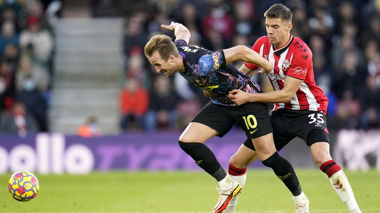 Harry Kane and Jan Bednarek battle for possession