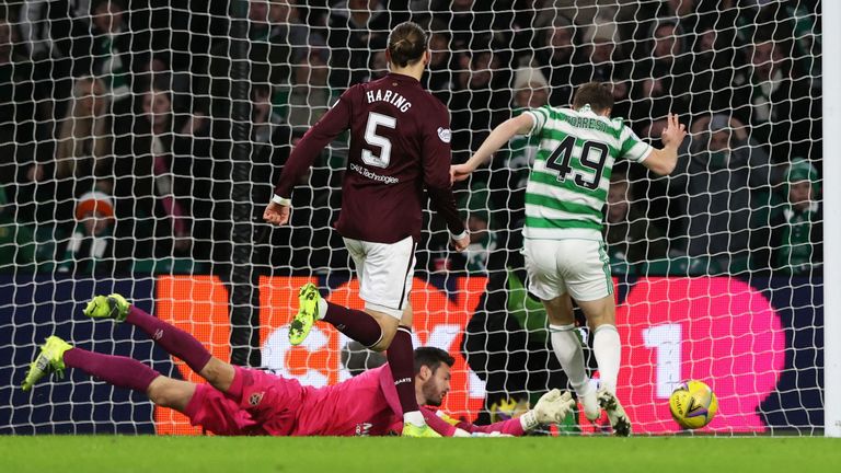 GLASGOW, SCOTLAND - DECEMBER 02: Hearts goalkeeper Craig Gordon gets enough on the ball to put off James Forrest during a cinch Premiership match between Celtic and Heart of Midlothian at Celtic Park, on December 02, 2021, in Glasgow, Scotland. (Photo by Craig Williamson / SNS Group)