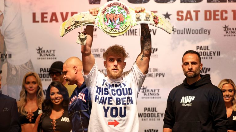 Jake Paul poses with a T-shirt mocking Tommy Fury at the weigh-in ahead of his fight with Tyron Woodley