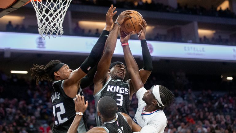 Sacramento Kings center Richaun Holmes (22), guard Terence Davis (3) and guard De&#39;Aaron Fox (5) compete for a rebound with with Los Angeles Clippers guard Reggie Jackson during the second half of an NBA basketball game in Sacramento, Calif., Saturday, Dec. 4, 2021. The Kings won 104-99. (AP Photo/Randall Benton)


