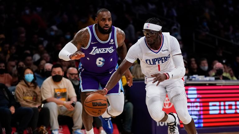 Los Angeles Lakers forward LeBron James (6) defends against Los Angeles Clippers guard Reggie Jackson (1) during the first half of an NBA basketball game in Los Angeles, Friday, Dec. 3, 2021. (AP Photo/Ashley Landis)  