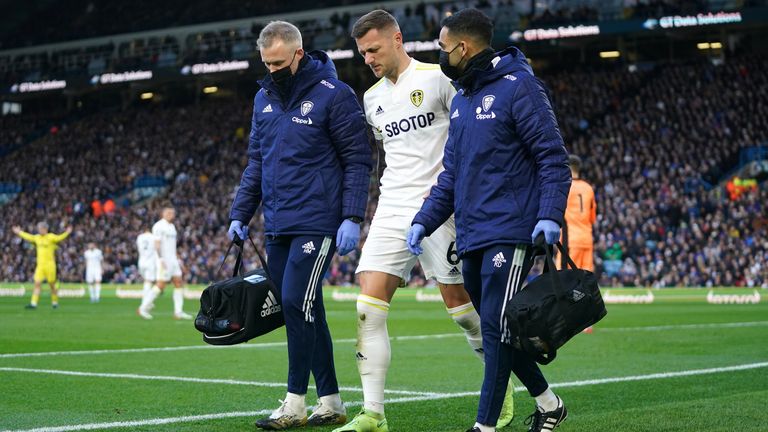 Leeds United&#39;s Liam Cooper leaves the pitch with an injury during the Premier League match against Brentford