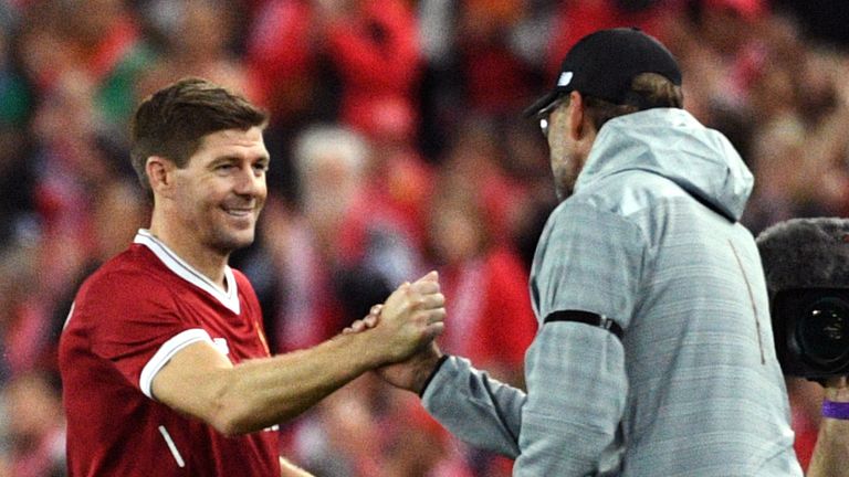Liverpool player Steven Gerrard (2nd L) shakes hands with coach Jurgen Klopp after being substituted during their end-of-season friendly football match against Sydney FC at the Olympic Stadium in Sydney on May 24, 2017.