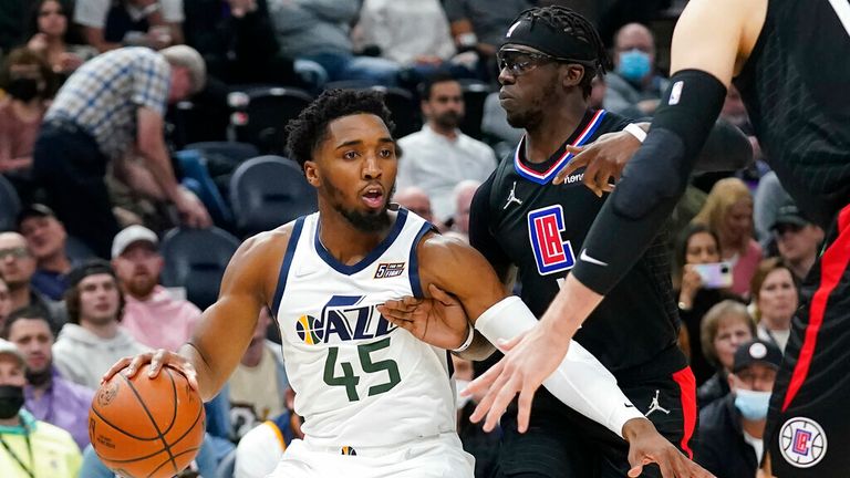 Los Angeles Clippers guard Reggie Jackson, right, guards Utah Jazz guard Donovan Mitchell (45) in the first half during an NBA basketball game Wednesday, Dec. 15, 2021, in Salt Lake City. (AP Photo/Rick Bowmer)