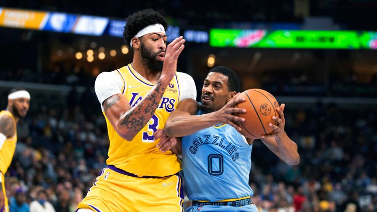 Los Angeles Lakers forward Anthony Davis (3) defends against guard De&#39;Anthony Melton (0) in the first half of an NBA basketball game Thursday, Dec. 9, 2021, in Memphis, Tenn. (AP Photo/Nikki Boertman)