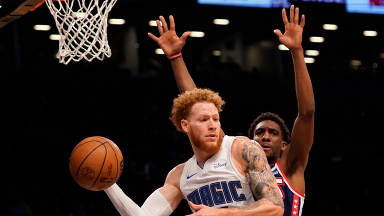 Orlando Magic guard Hassani Gravett (12) moves the ball around Brooklyn Nets guard Langston Galloway during the first half of an NBA basketball game, Saturday, Dec. 18, 2021, in New York. (AP Photo/Mary Altaffer)


