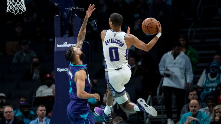 Sacramento Kings guard Tyrese Haliburton scores a layup over Charlotte Hornets forward Cody Martin