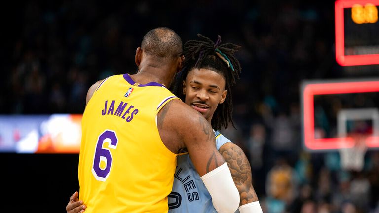 Los Angeles Lakers forward LeBron James (6) embraces Memphis Grizzlies guard Ja Morant (12) in the second half of an NBA basketball game Wednesday, Dec. 29, 2021, in Memphis, Tenn. (AP Photo/Nikki Boertman)