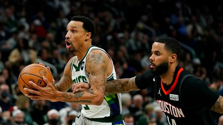 Milwaukee Bucks&#39; George Hill is fouled by Houston Rockets&#39; D.J. Augustin during the second half of an NBA basketball game Wednesday, Dec. 22, 2021, in Milwaukee. (AP Photo/Morry Gash)