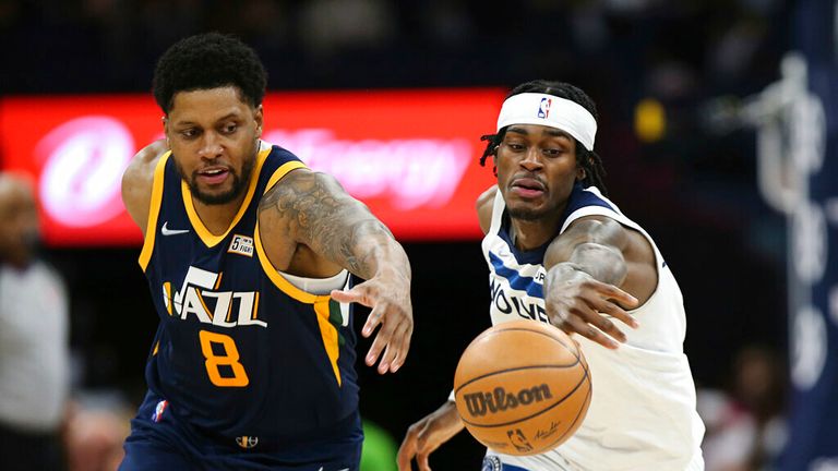 forward Jarred Vanderbilt (8) and Utah Jazz forward Rudy Gay (8) go after a loose ball during the second half of an NBA basketball game Wednesday Dec. 8, 2021, in Minneapolis. Utah won 136-104. (AP Photo/Stacy Bengs)