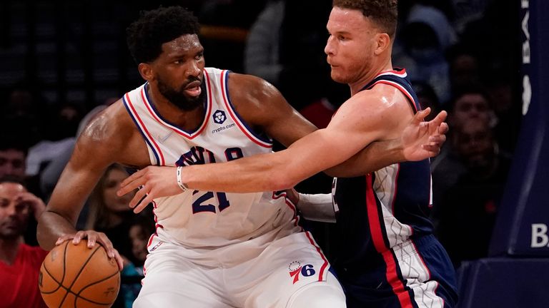 Philadelphia 76ers center Joel Embiid (21) drives against Brooklyn Nets forward Blake Griffin during the second half of an NBA basketball game, Thursday, Dec. 16, 2021, in New York. 