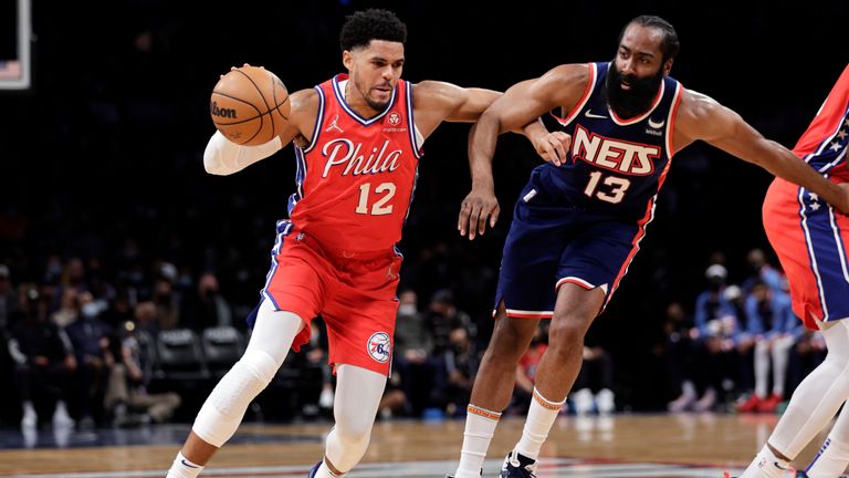 Philadelphia 76ers forward Tobias Harris (12) drives past Brooklyn Nets guard James Harden (13) during the first half of an NBA basketball game Thursday, Dec. 30, 2021, in New York. (AP Photo/Adam Hunger)


