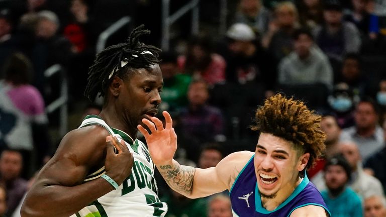 Charlotte Hornets&#39; LaMelo Ball tries to get past Milwaukee Bucks&#39; Jrue Holiday during the first half of an NBA basketball game Wednesday, Dec. 1, 2021, in Milwaukee. (AP Photo/Morry Gash)


