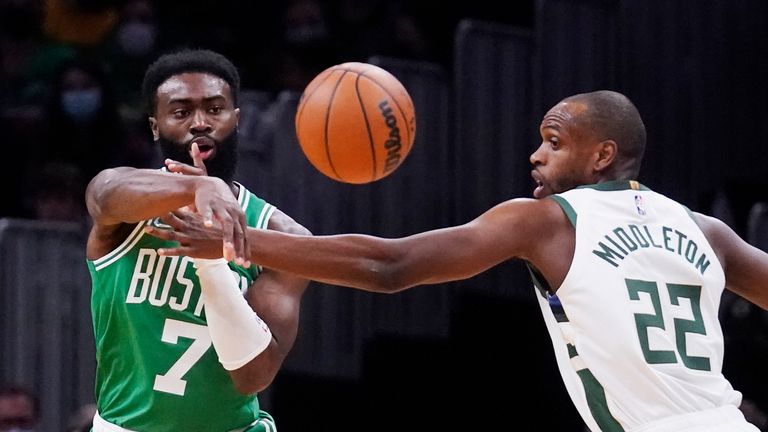 Boston Celtics guard Jaylen Brown (7) passes the ball while pressured by Milwaukee Bucks forward Khris Middleton (22) during the first half of an NBA basketball game, Monday, Dec. 13, 2021, in Boston. (AP Photo/Charles Krupa)


