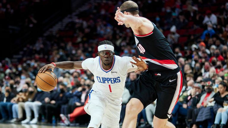 Los Angeles Clippers guard Reggie Jackson, left, dribbles around Portland Trail Blazers center Cody Zeller during the first half of an NBA basketball game in Portland, Ore., Monday, Dec. 6, 2021. (AP Photo/Craig Mitchelldyer)


