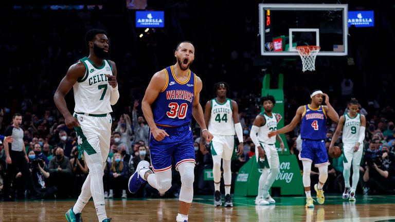 Golden State Warriors guard Stephen Curry (30) reacts after hitting a three point shot as Boston Celtics guard Jaylen Brown (7) looks on during the first half of an NBA basketball game, Friday, Dec. 17, 2021, in Boston. (AP Photo/Mary Schwalm)


