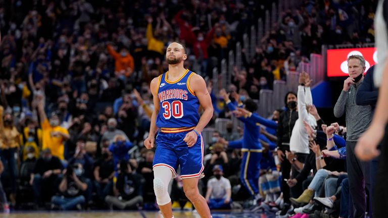 Golden State Warriors guard Stephen Curry (30) reacts after shooting a 3-point basket during the second half of his team&#39;s NBA basketball game against the Denver Nuggets in San Francisco, Tuesday, Dec. 28, 2021. (AP Photo/Jeff Chiu)


