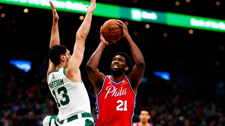 Joel Embiid #21 of the Philadelphia 76ers drives to the basket on Enes Freedom #13 of the Boston Celtics during the first quarter of the game against the Boston Celtics at TD Garden on December 20, 2021 in Boston, Massachusetts.