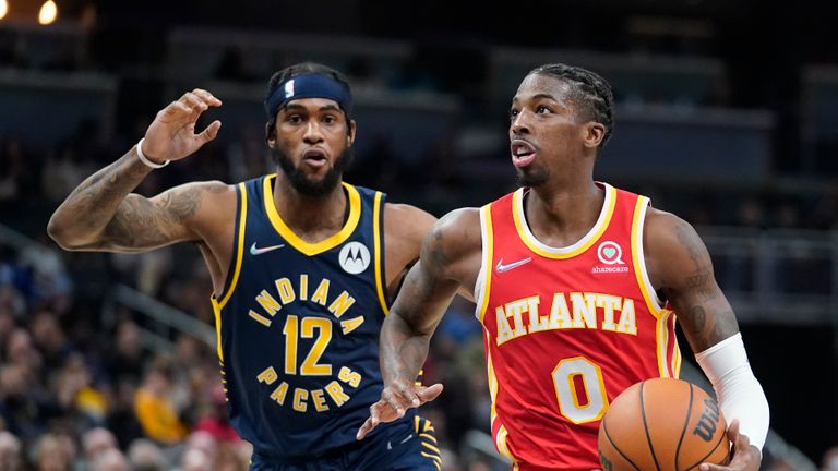 Atlanta Hawks&#39; Delon Wright (0) goes to the basket against Indiana Pacers&#39; Oshae Brissett (12) during the first half of an NBA basketball game Wednesday, Dec. 1, 2021, in Indianapolis. (AP Photo/Darron Cummings)


