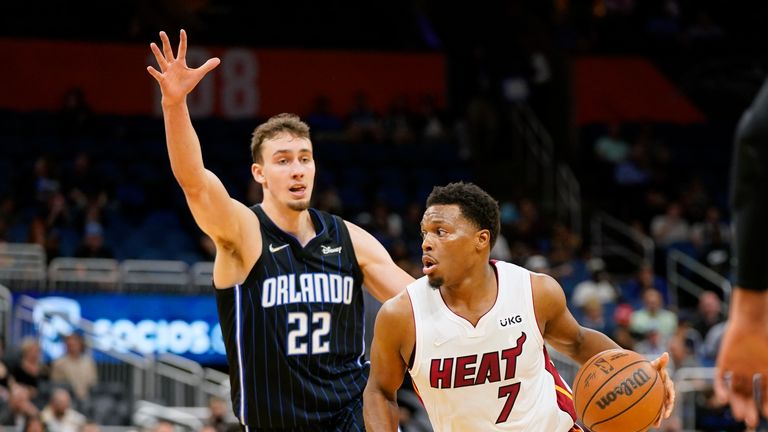 Miami Heat guard Kyle Lowry (7) leads Orlando Magic forward Franz Wagner (22) during the first half of an NBA basketball game, Friday, Dec. 17, 2021, in Orlando, Florida (AP Photo/John Raoux)