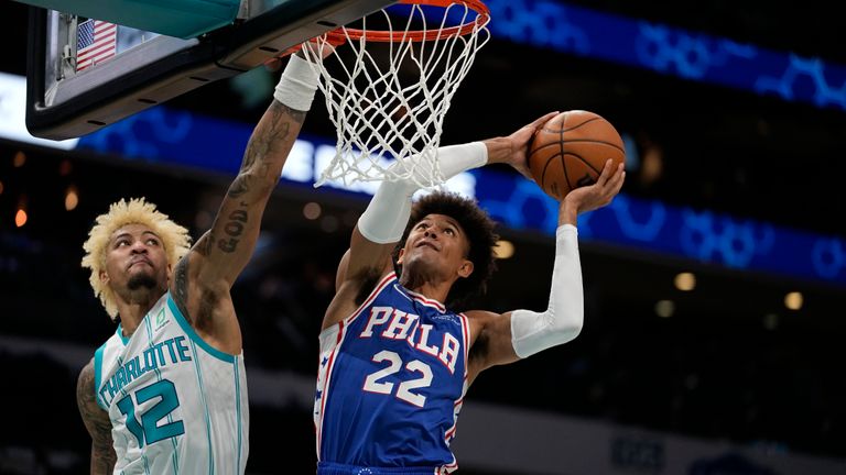Philadelphia 76ers guard Matisse Thybulle scores past Charlotte Hornets guard Kelly Oubre Jr. during the second half of an NBA basketball game on Monday, Dec. 6, 2021, in Charlotte, N.C. The 76ers won 127-124 in overtime. (AP Photo/Chris Carlson)


