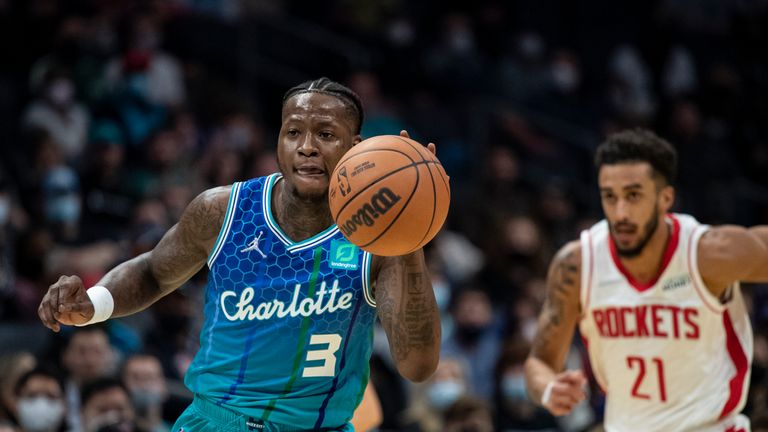 Charlotte Hornets guard Terry Rozier (3) drives the ball up court past Houston Rockets guard Trevelin Qeen (21) during the first half of an NBA basketball game Monday, Dec. 27, 2021, in Charlotte, N.C. (AP Photo/Matt Kelley)


