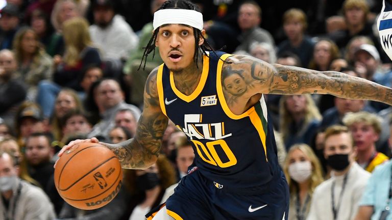 Jordan Clarkson #00 of the Utah Jazz drives around Naz Reid #11 of the Minnesota Timberwolves in the first half of a game at Vivint Smart Home Arena on December 23, 2021 in Salt Lake City, Utah. 