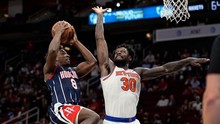 Houston Rockets&#39; Jae&#39;Sean Tate (8) is fouled by New York Knicks&#39; Julius Randle (30) during the second half of an NBA basketball game Thursday, Dec. 16, 2021, in Houston.