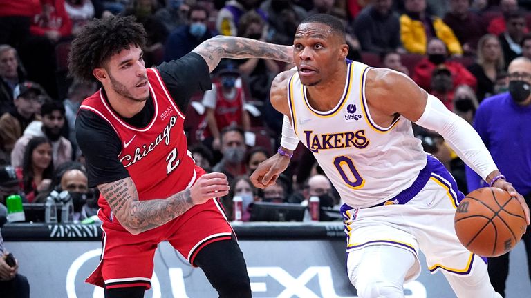 Los Angeles Lakers guard Russell Westbrook, right, drive to the basket against Chicago Bulls guard Lonzo Ball during the first half of an NBA basketball game in Chicago, Sunday, Dec. 19, 2021. 