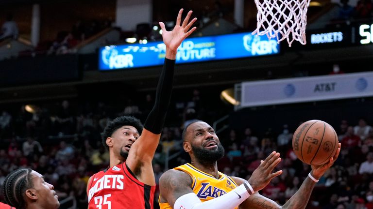 Los Angeles Lakers forward LeBron James, right, shoots as Houston Rockets center Christian Wood (35) defends during the first half of an NBA basketball game Tuesday, Dec. 28, 2021, in Houston. (AP Photo/Eric Christian Smith)  