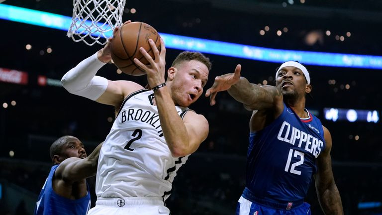 Brooklyn Nets' Blake Griffin, left, gets a rebound next to Los Angeles Clippers' Eric Bledsoe during first half of an NBA basketball game Monday, Dec. 27, 2021, in Los Angeles. (AP Photo/Jae C. Hong)  