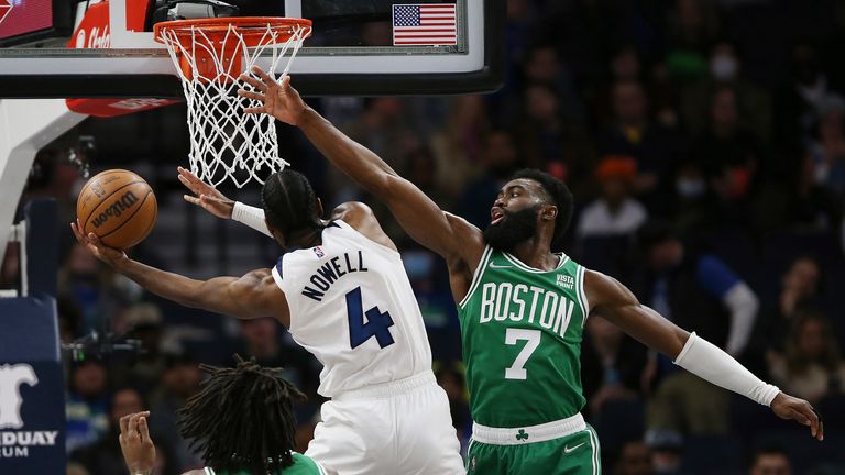 Minnesota Timberwolves guard Jaylen Nowell (4) shoots against Boston Celtics guard Jaylen Brown (7) during the first half of an NBA basketball game Monday, Dec. 27, 2021, in Minneapolis. (AP Photo/Stacy Bengs)


