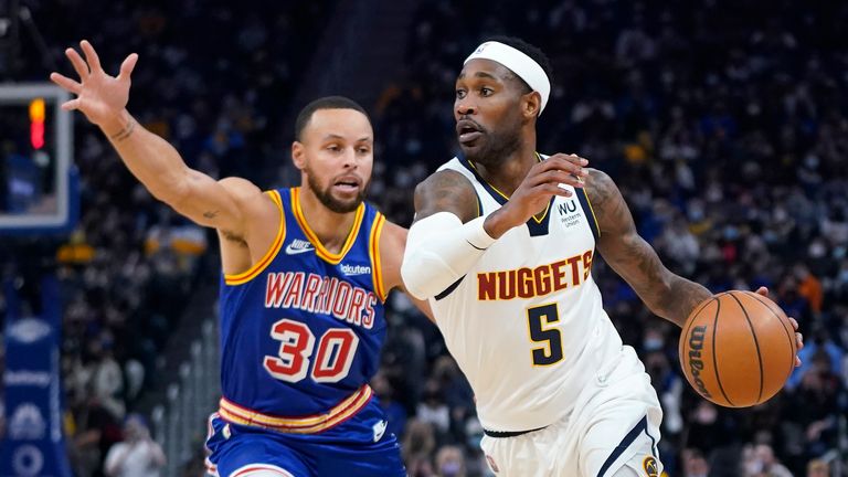 Denver Nuggets forward Will Barton (5) drives to the basket against Golden State Warriors guard Stephen Curry (30) during the first half of an NBA basketball game in San Francisco, Tuesday, Dec. 28, 2021. (AP Photo/Jeff Chiu)  