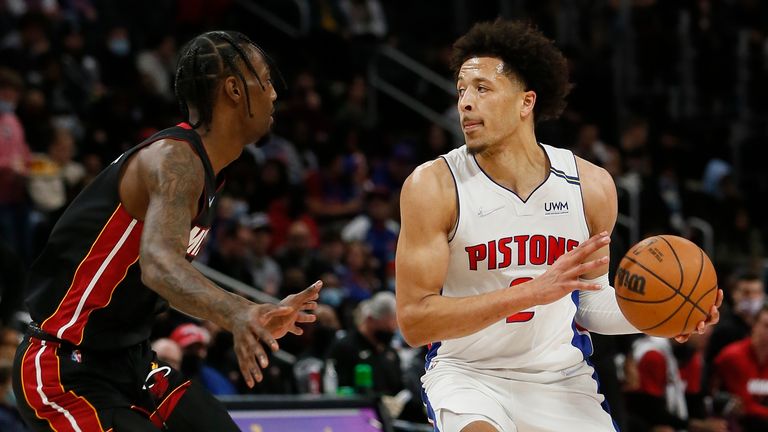 Detroit Pistons guard Cade Cunningham, right, looks to pass against Miami Heat forward KZ Okpala during the first half of an NBA basketball game Sunday, Dec. 19, 2021, in Detroit.