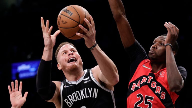 Brooklyn Nets forward Blake Griffin (2) drives to the basket past Toronto Raptors forward Chris Boucher (25) during the second half of an NBA basketball game Tuesday, Dec. 14, 2021, in New York. The Nets won 131-129 in overtime.