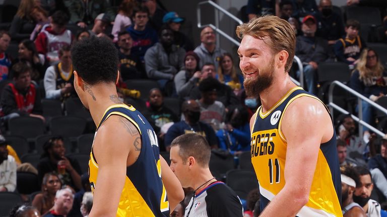 Domantas Sabonis #11 of the Indiana Pacers hi-fives teammates during the game against the Detroit Pistons on December 16, 2021 at Gainbridge Fieldhouse in Indianapolis, Indiana.
