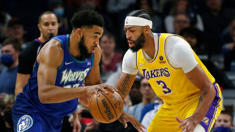 Minnesota Timberwolves center Karl-Anthony Towns (32) works past Los Angeles Lakers forward Anthony Davis (3) in the first quarter of an NBA basketball game on Friday, December 17, 2021 in Minneapolis.  (AP Photo / Bruce Kluckhohn)