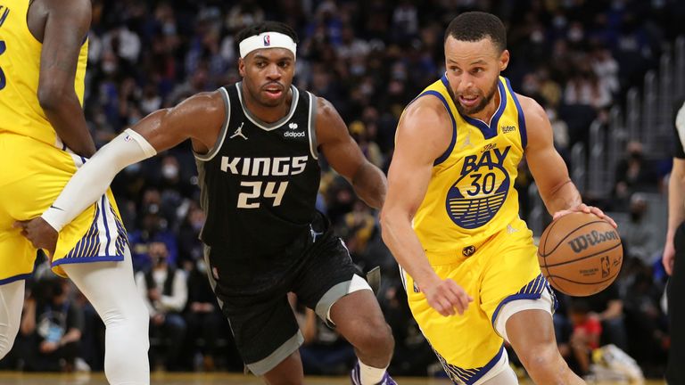 Golden State Warriors guard Stephen Curry (30) drives to the basket against Sacramento Kings guard Buddy Hield (24) during the second half of an NBA basketball game in San Francisco, Monday, Dec. 20, 2021. 