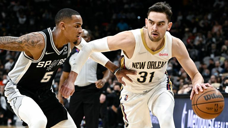 New Orleans Pelicans' Tomas Satoransky (31) drives against San Antonio Spurs' Dejounte Murray during the second half of an NBA basketball game, Sunday, Dec. 12, 2021, in San Antonio. San Antonio won 112-97. (AP Photo/Darren Abate)