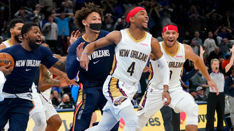 New Orleans Pelicans guard Devonte&#39; Graham (4) celebrates with teammates after hitting the game winning basket to end the second half of an NBA basketball game against the Oklahoma City Thunder, Wednesday, Dec. 15, 2021, in Oklahoma City. (AP Photo/Sue Ogrocki)